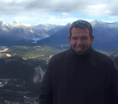 Owner Markus standing on mountaintop overlooking valley
