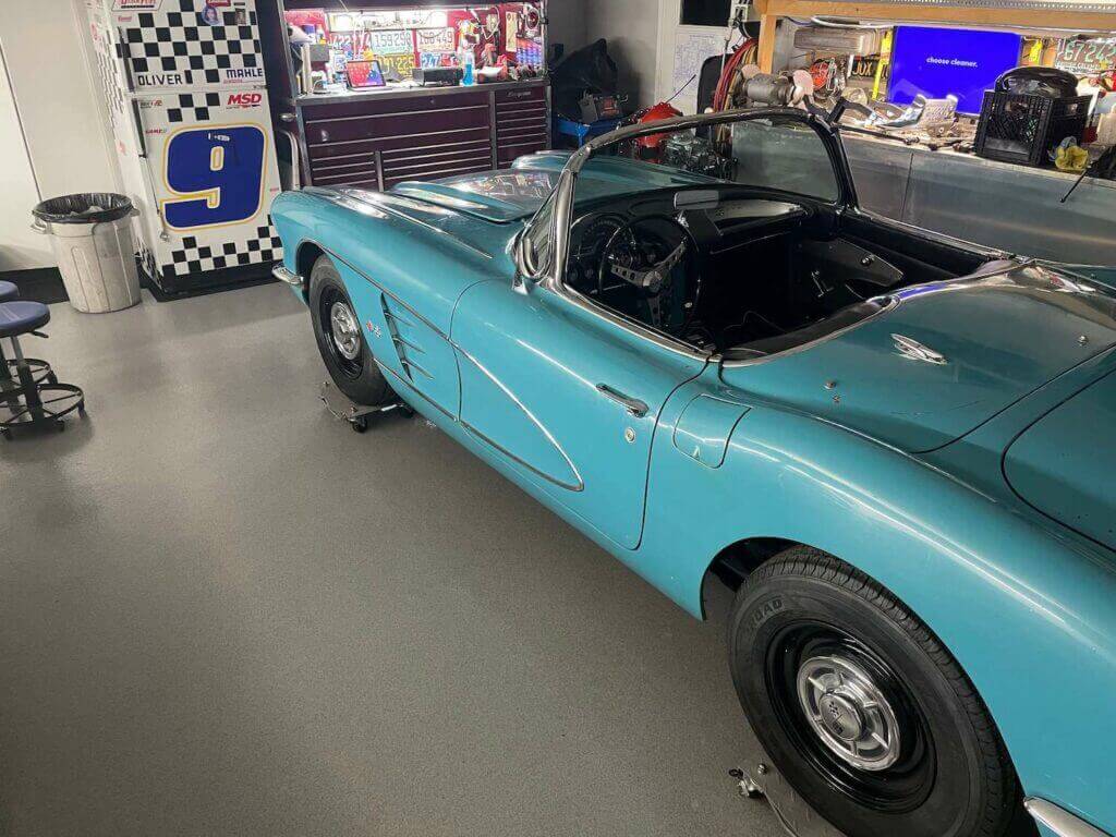 Blue corvette on new epoxy garage flooring with garage cabinets in Vancouver